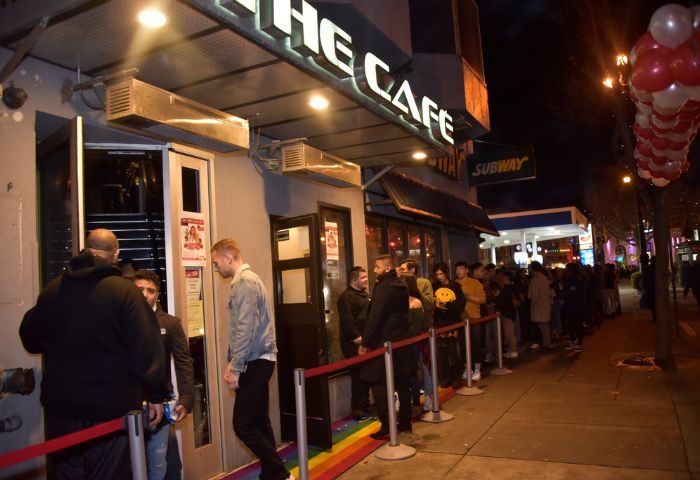 The Cafe Night Club in San Francisco. A line of gay men wait outside the popular gay bar and nightclub. Rainbow painted sidewalk.