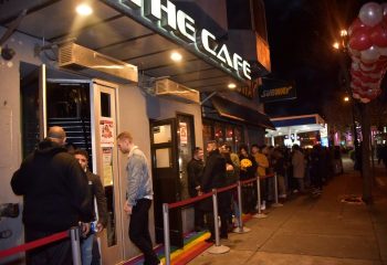 The Cafe Night Club in San Francisco. A line of gay men wait outside the popular gay bar and nightclub. Rainbow painted sidewalk.