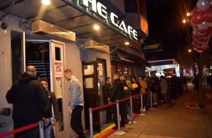 The Cafe Night Club in San Francisco. A line of gay men wait outside the popular gay bar and nightclub. Rainbow painted sidewalk.