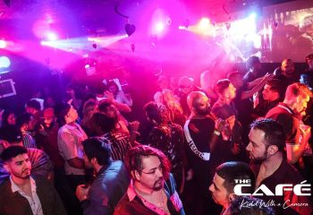 The Cafe Night Club in San Francisco: Gay men dancing under pink lights. Nightlife at a popular gay bar, a travel destination.