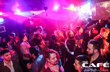 The Cafe Night Club in San Francisco: Gay men dancing under pink lights. Nightlife at a popular gay bar, a travel destination.