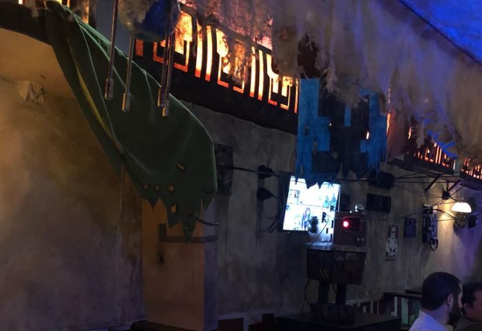 Interior of The Cinch Saloon in San Francisco, a gay bar. Quirky decor with TVs, robot, and unique lighting. A popular spot for gay men travelers.