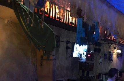 Interior of The Cinch Saloon in San Francisco, a gay bar. Quirky decor with TVs, robot, and unique lighting. A popular spot for gay men travelers.