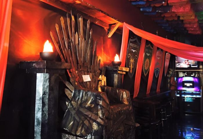 The Cinch Saloon in San Francisco: Game of Thrones-themed decor with a sword throne, banners, and torches. A popular gay bar for travel advice.