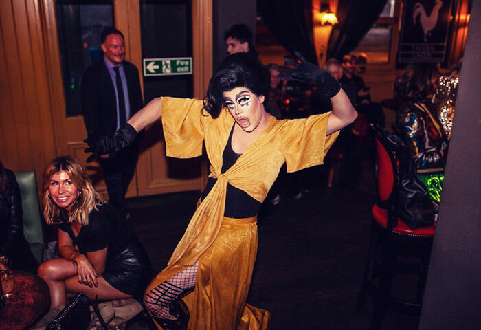 Drag queen performing at The Cock Tavern, a gay bar in London. The best gay bar for drag and cocktails, lively atmosphere.