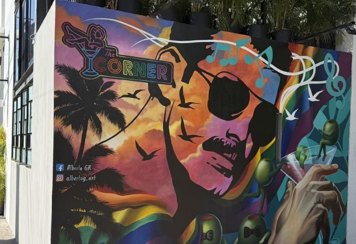 Mural art at The Corner Bar, a gay-friendly music venue in Puerto Vallarta. Features a face, palm trees, and cocktail elements.