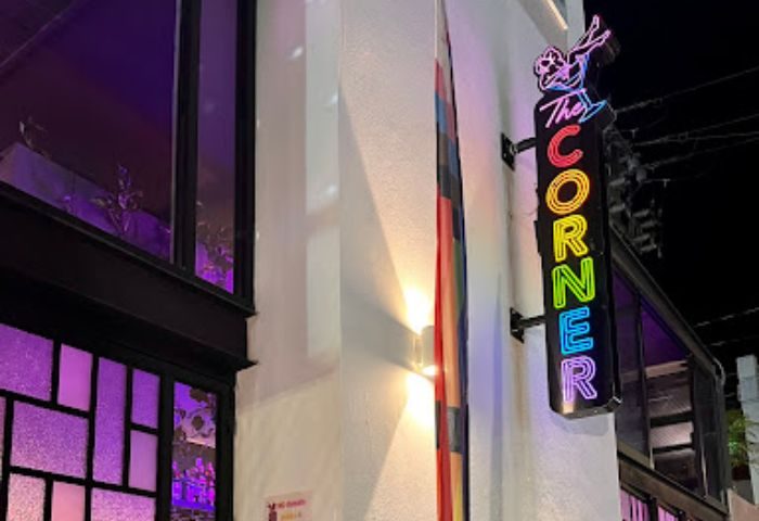 The Corner Bar neon sign, a gay place in Puerto Vallarta, Mexico, with colorful lights and a cocktail glass icon, inviting gay travelers.