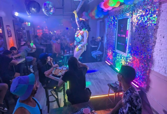 Nightlife at The Drink: Toronto's gay bar with drag shows, cocktails, pizza, and a vibrant atmosphere. A must-visit for gay men's travel.