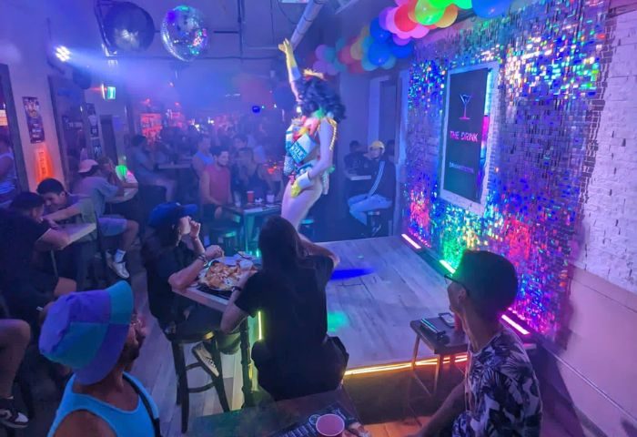 Nightlife at The Drink: Toronto's gay bar with drag shows, cocktails, pizza, and a vibrant atmosphere. A must-visit for gay men's travel.