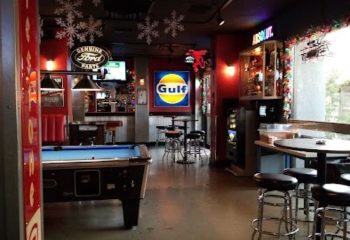 The Garage Bar in Las Vegas, a gay travel destination. Pool table, bar stools, and automotive decor create a unique, fun atmosphere.