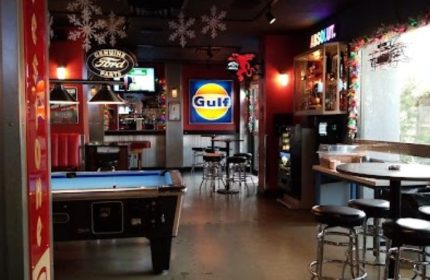 The Garage Bar in Las Vegas, a gay travel destination. Pool table, bar stools, and automotive decor create a unique, fun atmosphere.