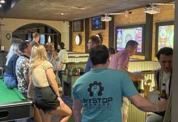 The Glenwood gay bar in Chicago: patrons socializing, playing darts, and drinking. Nightlife scene with a relaxed, friendly atmosphere.