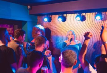 Drag queens perform at The Goose, Manchester. Gay men enjoy the show in a vibrant, inclusive atmosphere. Nightlife and travel advice.