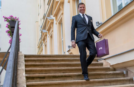 The Grand Mark Prague: Hotel staff member on stairs. Luxury gay-friendly hotel near gay saunas. Gay travel advice.