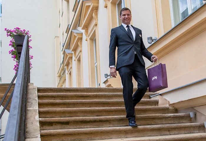 The Grand Mark Prague: Hotel staff member on stairs. Luxury gay-friendly hotel near gay saunas. Gay travel advice.