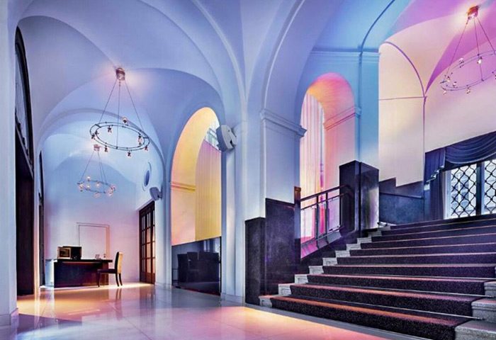 The Grand Mark Prague luxury hotel lobby with arched ceilings, chandeliers, and staircase. Popular honeymoon choice for gay couples.