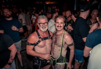The Laird Melbourne: Two gay men pose at a leather night. One wears a harness, the other a singlet. Gay travel advice.