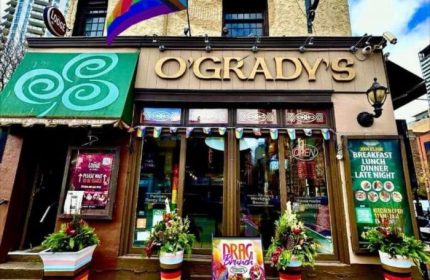 O'Grady's, a gay-friendly lodge in Toronto, Canada. Rainbow flags adorn the entrance. The Lodge at O'Gradys is a popular gay bar.