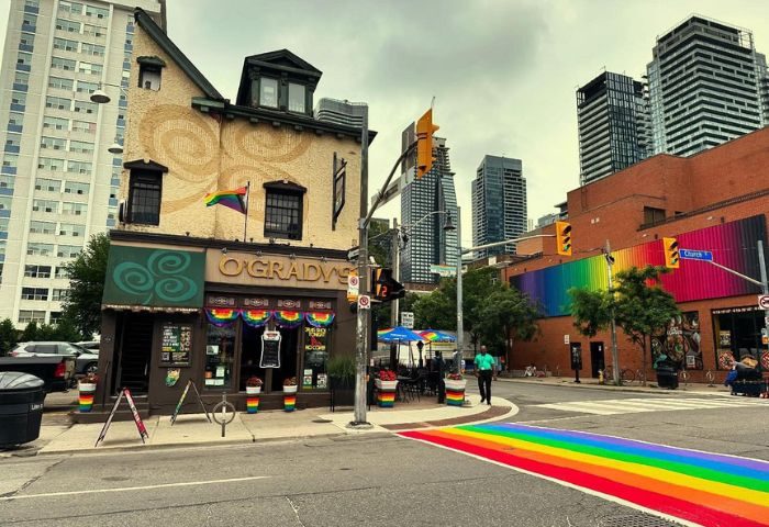 The Lodge at O'Gradys in Toronto. Gay bar with rainbow crosswalk, rainbow mural, and rainbow flag. Gay travel in Canada's largest city.