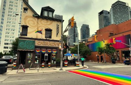 The Lodge at O'Gradys in Toronto. Gay bar with rainbow crosswalk, rainbow mural, and rainbow flag. Gay travel in Canada's largest city.