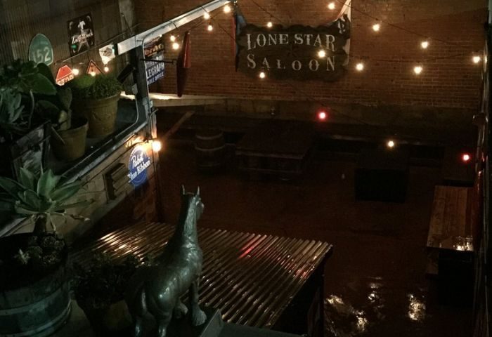 Lone Star Saloon in San Francisco. Gay bar's patio with lights, plants, horse statue, and Lone Star Saloon sign. Gay travel destination.