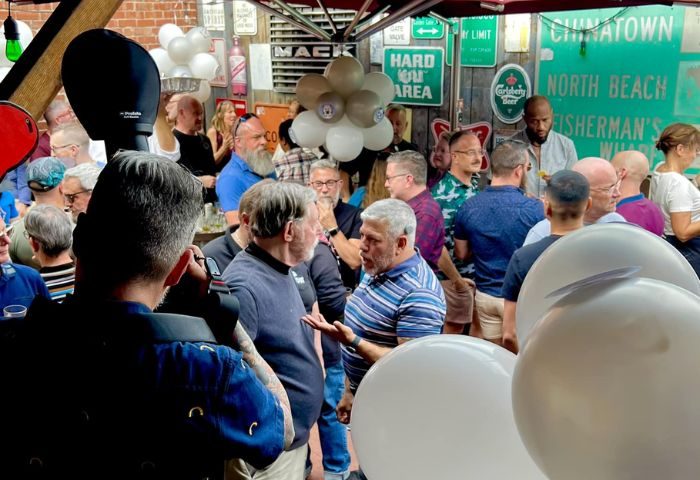 Lone Star Saloon: Gay men gather at a popular bar in San Francisco. The bar is decorated with balloons and vintage signs.