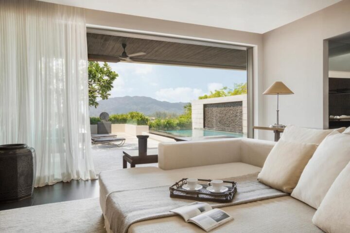 The Pavilions Phuket gay hotel suite view. Pool, mountains, and modern design. Luxury gay travel in Phuket, Thailand. Relaxing getaway.