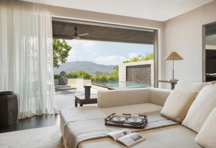The Pavilions Phuket gay hotel suite view. Pool, mountains, and modern design. Luxury gay travel in Phuket, Thailand. Relaxing getaway.