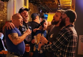 Gay bear bar fun: SoFo Tap in Chicago shows a group of men singing karaoke, enjoying drinks, and having a great time at this popular gay bar.