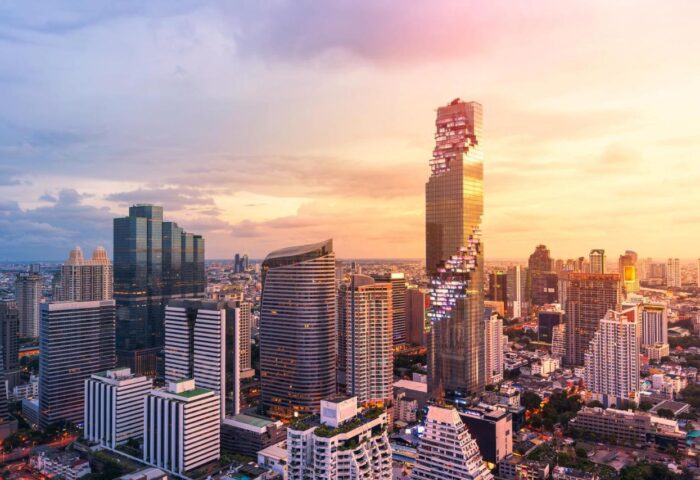 Bangkok skyline featuring the Mahanakhon building at sunset. The Standard Bangkok is a gay-friendly hotel with stunning city views.