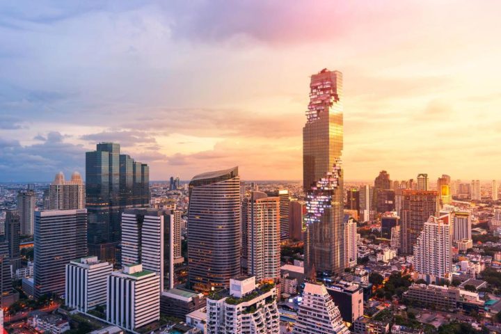 Bangkok skyline featuring the Mahanakhon building at sunset. The Standard Bangkok is a gay-friendly hotel with stunning city views.