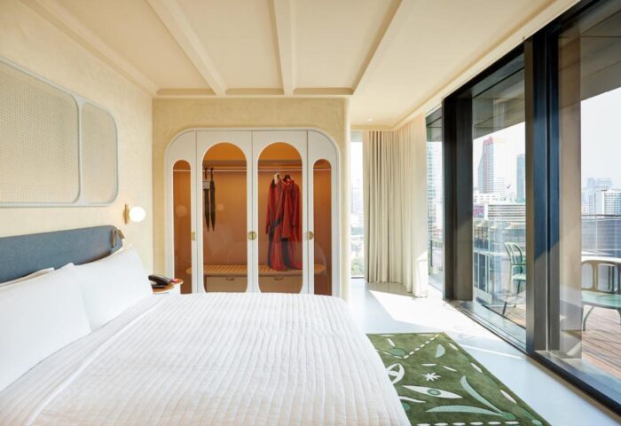 The Standard Bangkok Mahanakhon hotel room. Modern design with bed, closet, and city view. Gay travel in Silom, Thailand.