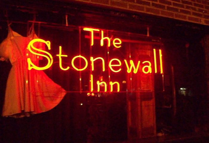 The Stonewall Inn in New York. Neon sign with dress. Gay travel destination. LGBTQ+ landmark. Historic gay bar. Gay men's travel advice.