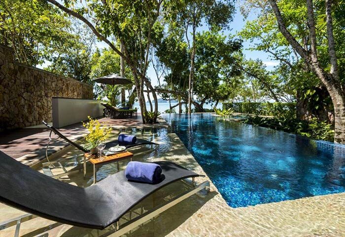 The Tubkaak Krabi Boutique Resort pool view. Luxury gay hotel in Krabi, Thailand. Relaxing sunbeds near the infinity pool, ocean view.