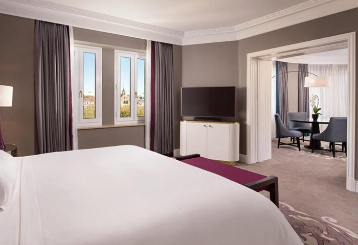 The Westin Palace, Madrid gay honeymoon hotel idea: bedroom with a sitting area. A luxury travel option for gay men this year.