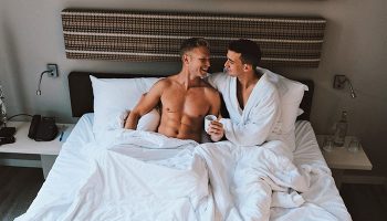 Gay Amsterdam honeymoon: Two men in bed at The Albus Hotel, Amsterdam City Centre. Gay couple enjoying their stay in Amsterdam.