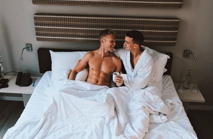 Gay Amsterdam honeymoon: Two men in bed at The Albus Hotel, Amsterdam City Centre. Gay couple enjoying their stay in Amsterdam.