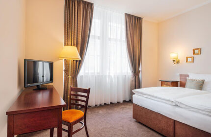 Hotel Leonardo Prague room. This gay-friendly hotel in Prague's Old Town offers comfortable lodging. Features include a desk, TV, and cozy bed.