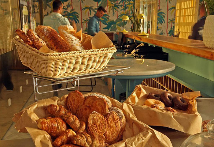 Breakfast pastries at Gold Playa del Ingles, an adults-only gay hotel in Gran Canaria. Breads, croissants, and donuts are displayed.