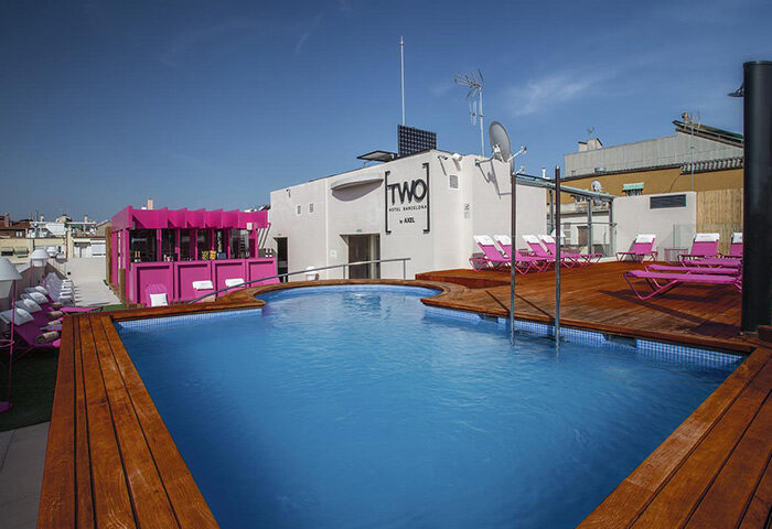 TWO Hotel Barcelona by Axel pool area. Best gay adult-only hotel in Barcelona. Rooftop pool with pink accents. Gay travel advice.