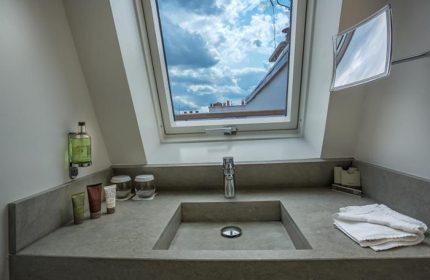 Bathroom at Hôtel Jules & Jim, a gay adult-only hotel in Paris. Sink with a view of the sky. Modern design, natural light, and stylish amenities.