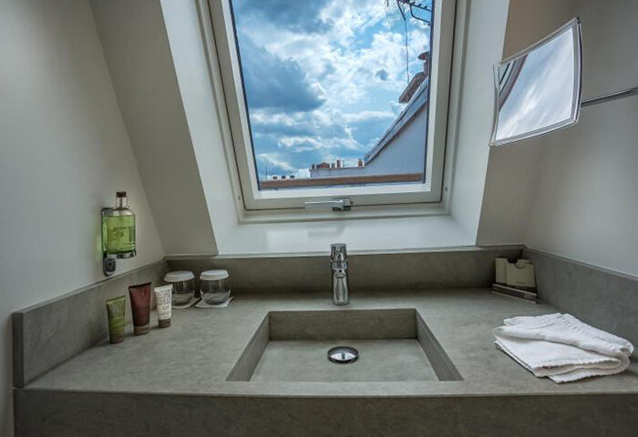 Bathroom at Hôtel Jules & Jim, a gay adult-only hotel in Paris. Sink with a view of the sky. Modern design, natural light, and stylish amenities.