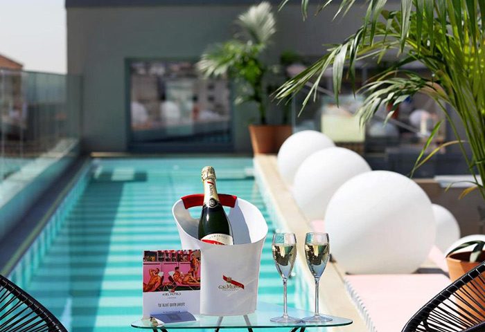 Axel Hotel Madrid Adults-Only rooftop pool with champagne. Best gay hotel in Madrid city center for gay men travel advice.