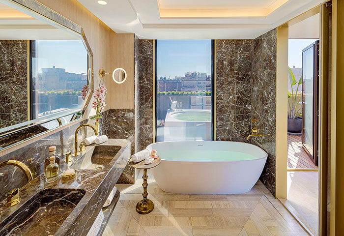 H10 The One Barcelona bathroom. Best gay honeymoon hotel in Barcelona's gayborhood. Bathtub, jacuzzi, and stylish design for gay travelers.