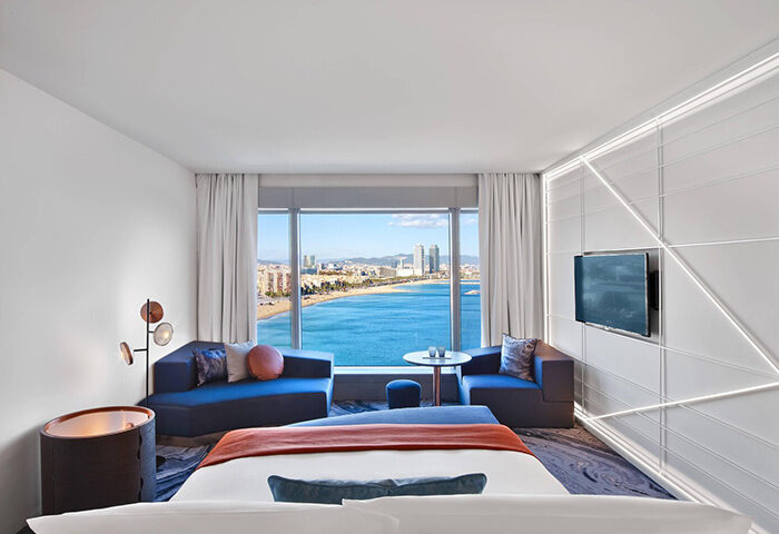 W Barcelona hotel room with ocean view. Best gay honeymoon hotel. Modern design, bright room, and beach view. Barcelona travel.