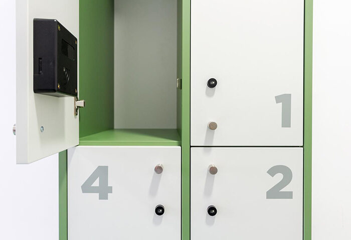 Private locker at Sant Jordi Hostels Rock Palace, Barcelona. This gay hostel offers secure storage for travelers. White doors, numbered 1, 2, and 4.