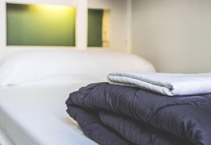 Sant Jordi Hostels Rock Palace private room. Best gay hostel with private bathroom. Cozy bed with a duvet and pillows. Gay travel.