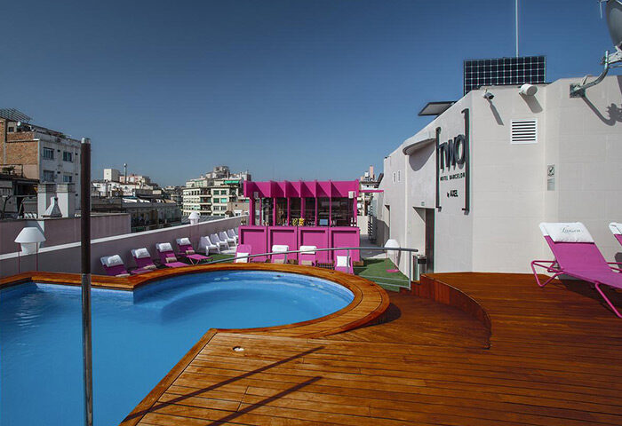 TWO Hotel Barcelona by Axel rooftop pool. Adults-only gay hotel with pink bar, sunbeds, and city views. Best gay hotel update.