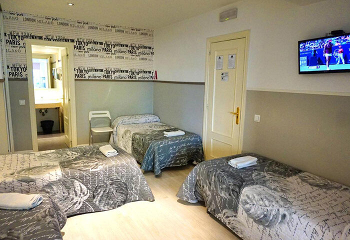 Far Home Gran Via: Triple room at Madrid's best gay hotel for 3 adults. Features 3 beds, TV, ensuite bathroom. Great for gayborhood travel.