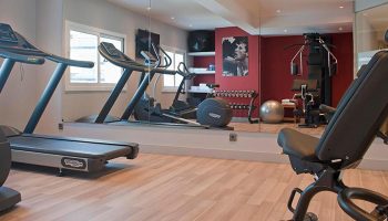 Hotel Calipolis gym with treadmills, weights, and workout equipment. A great amenity at this gay-friendly hotel near Playa De la Bassa Rodona.